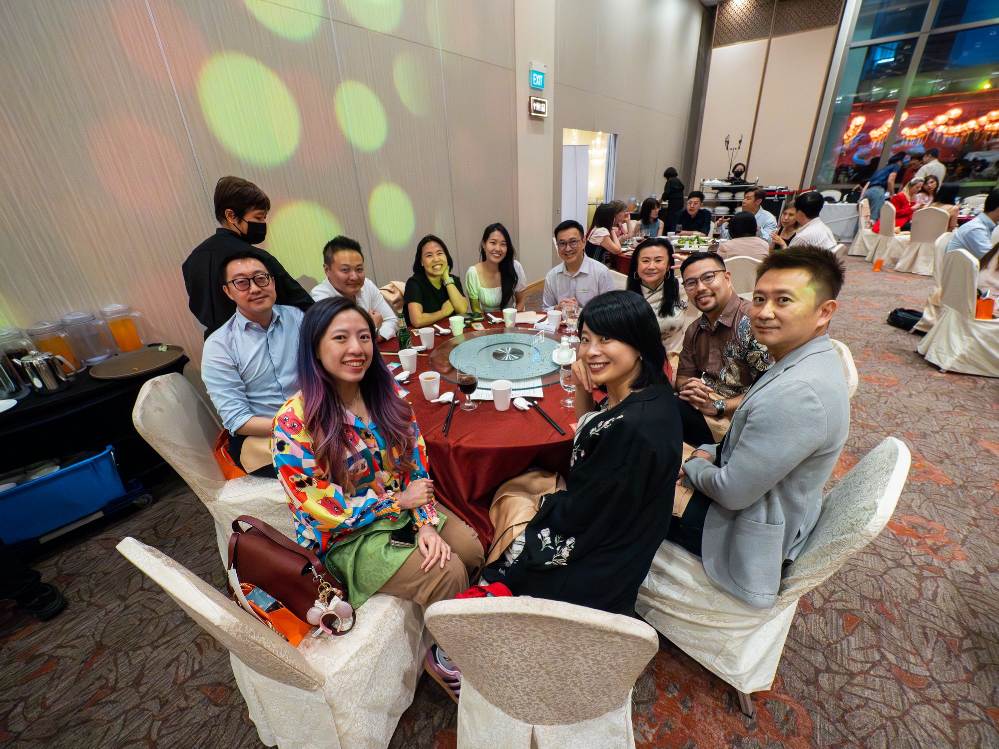 Guests at their table smile for the camera
