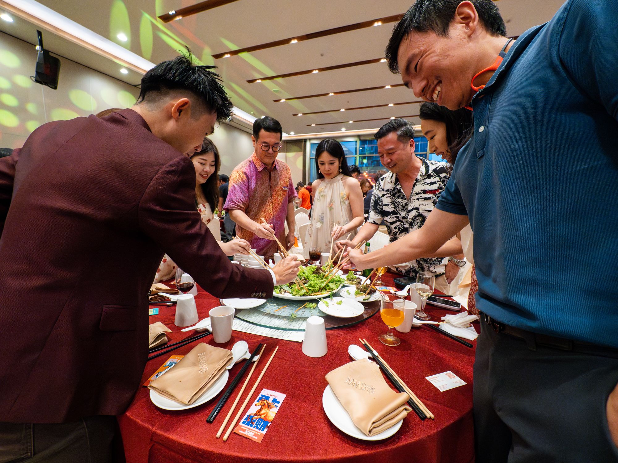 Guests toss yusheng for a prosperous year