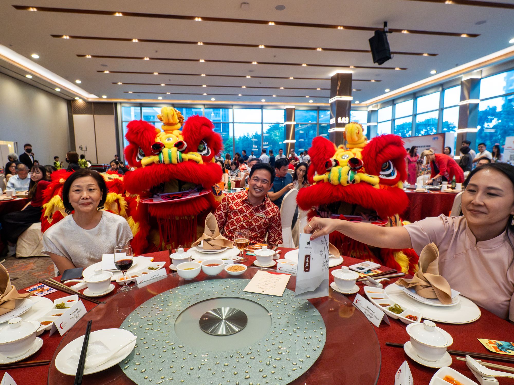 Lion dancers visit a table of guests