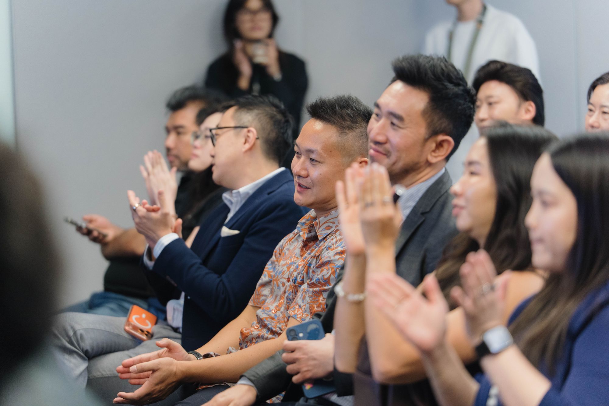Members applaud during the meeting