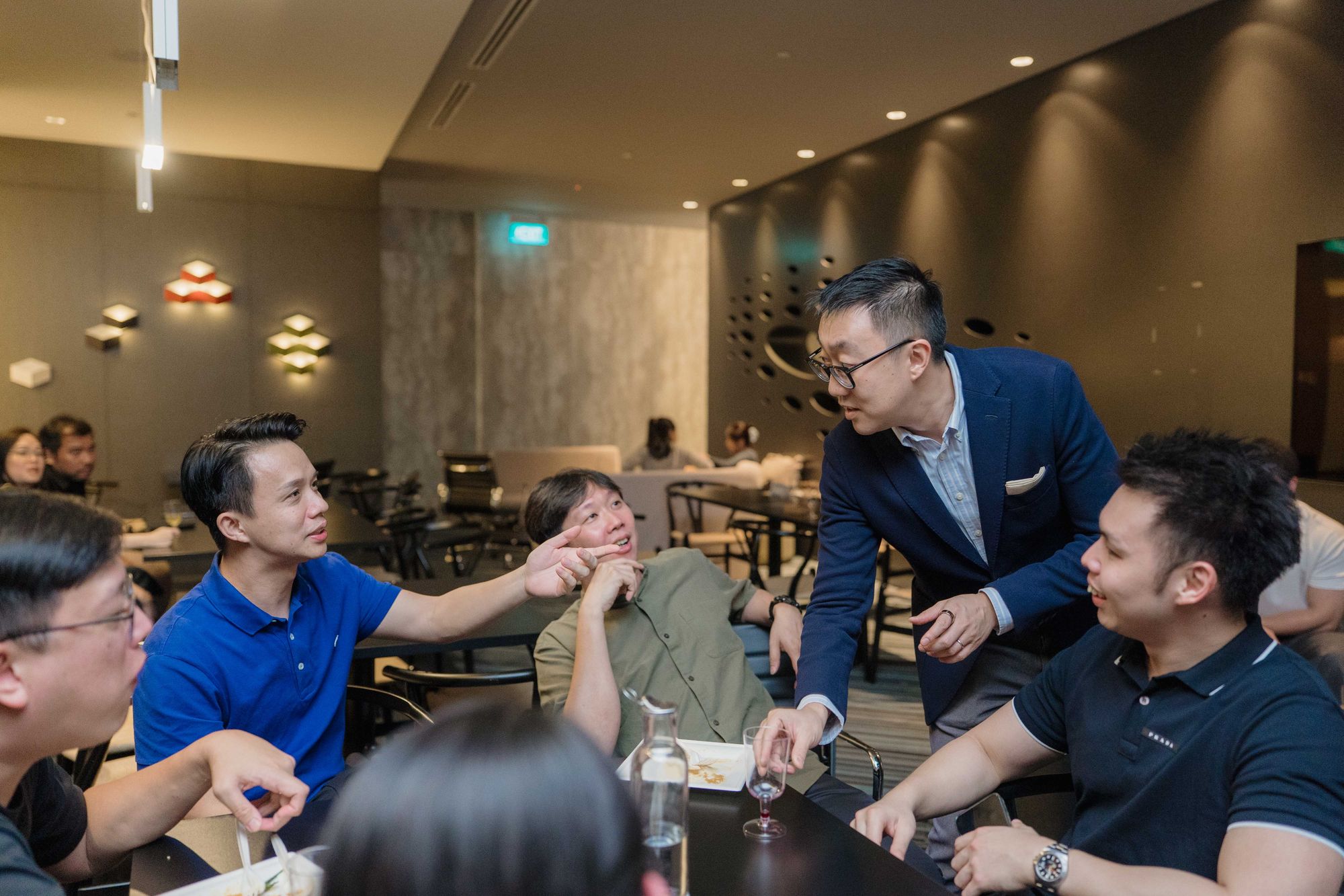 Members catch up over drinks after the meeting