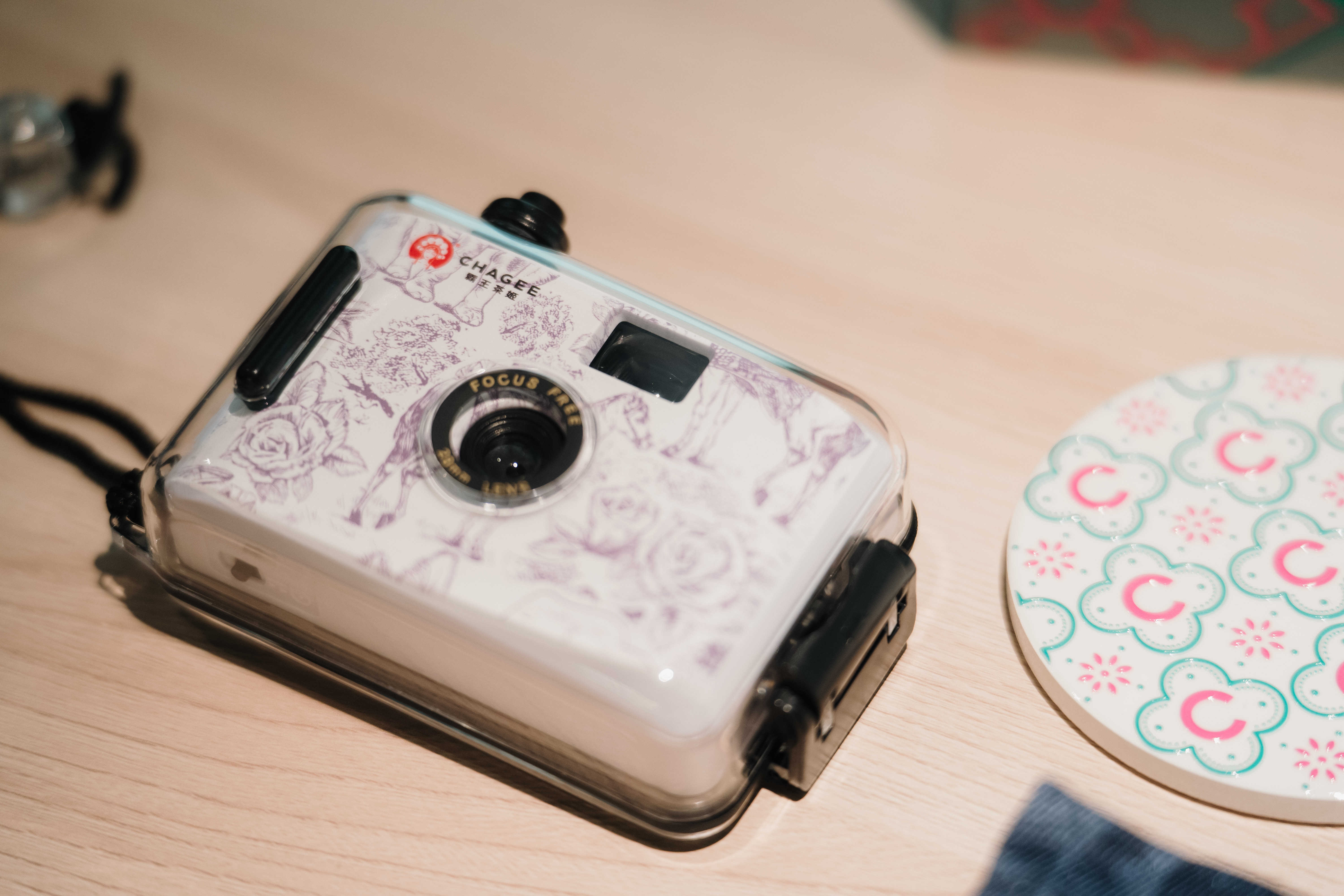 A branded camera and coaster on display at a vendor booth