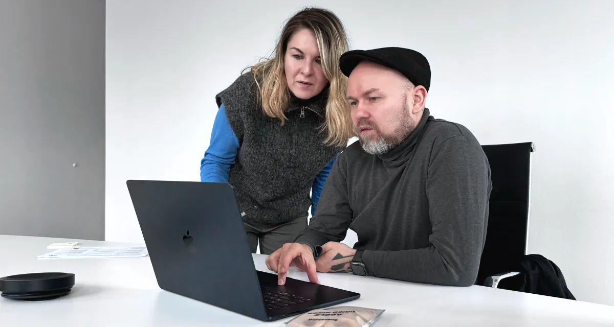User research photo depicting two people working on a laptop.