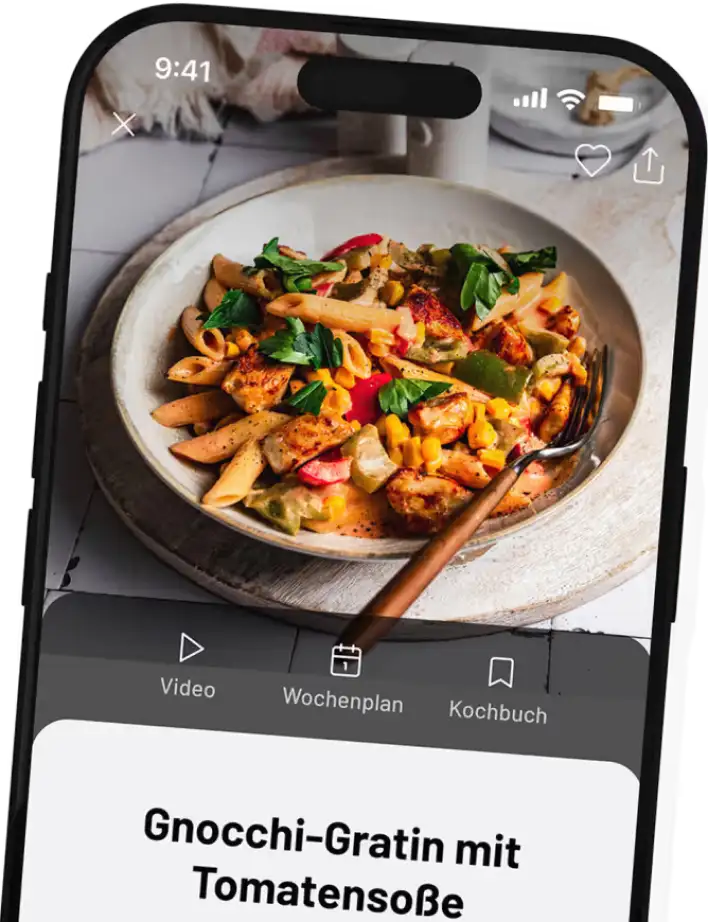 Smartphone screen showing a dish of penne pasta with grilled chicken, corn, red and green bell peppers, topped with fresh parsley, and a fork on the side.