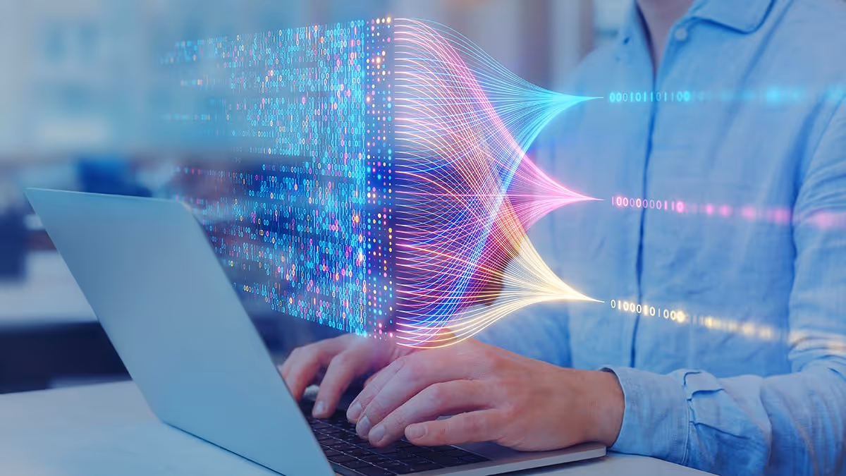 Person typing on a laptop with an abstract data flow of integrations graphic overlay.