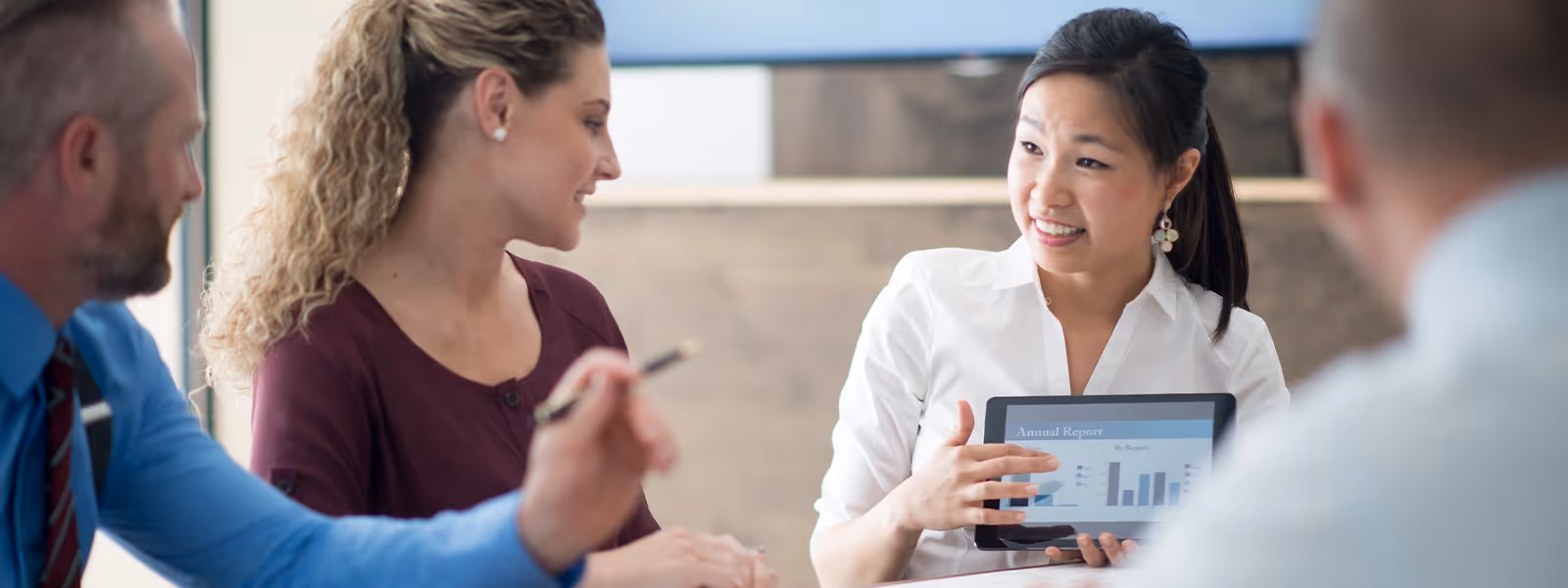 Finance team reviewing budget charts and reports on a laptop during portfolio reconciliation