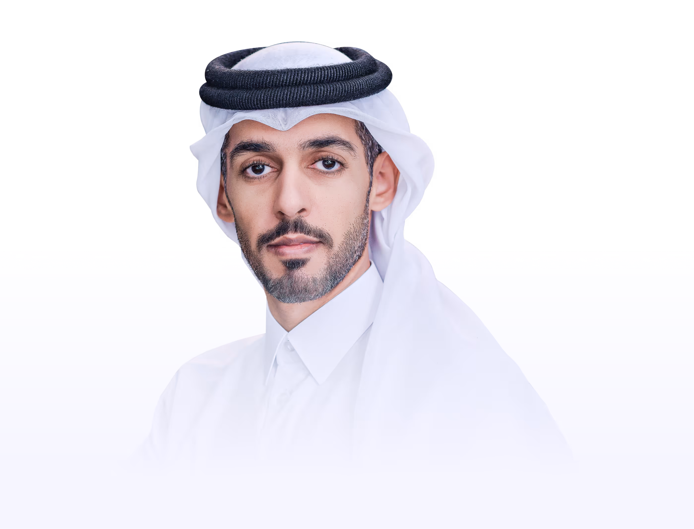 Portrait of a man wearing traditional white Middle Eastern attire and head covering.