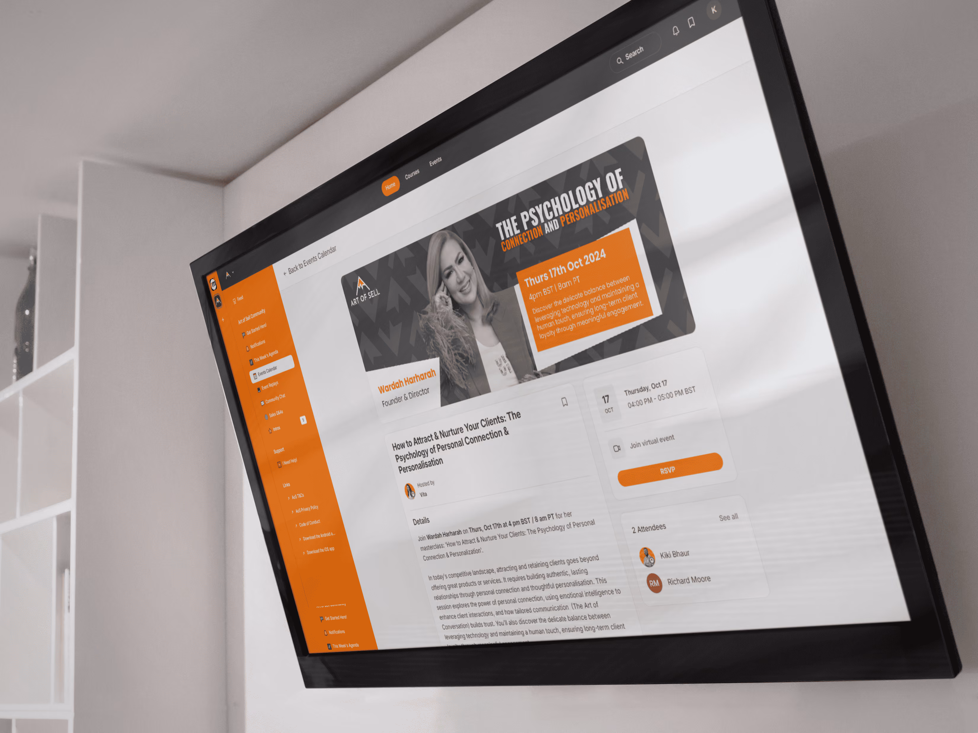 Wall-mounted TV displaying an event page for a psychology of connection masterclass with orange and gray design.