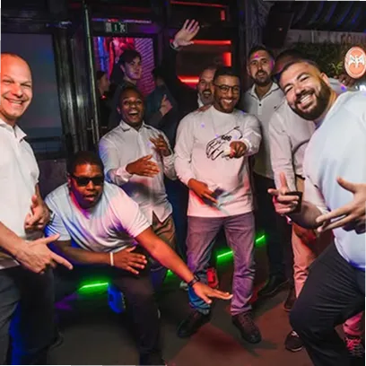 Modern office building with horizontal glass and metal panels, trees in front, and wide steps leading to the entrance.
