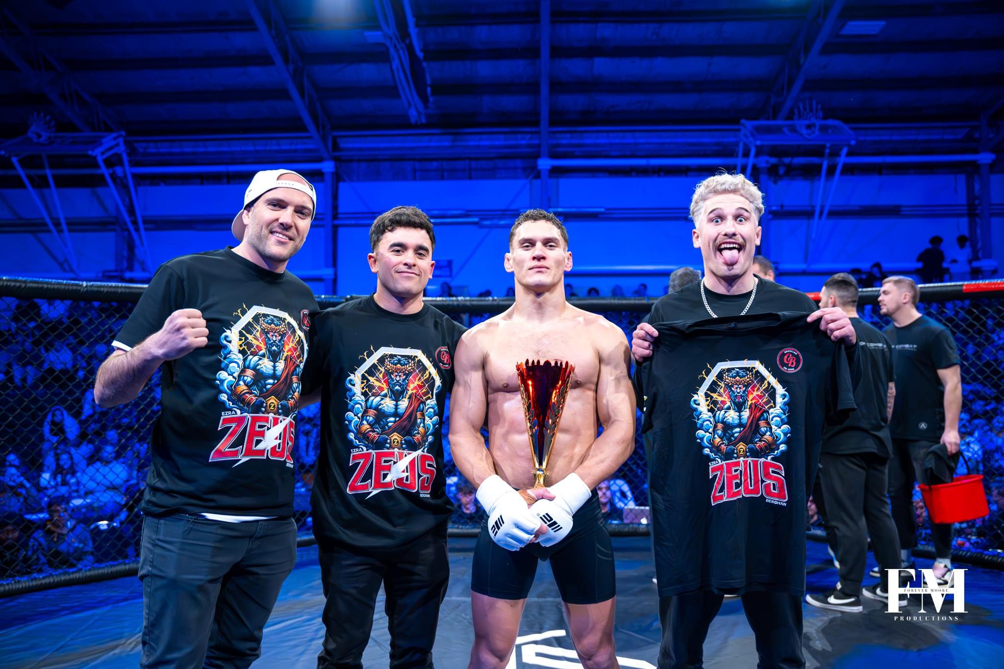 Athlete holding trophy alongside coaching team after a fight