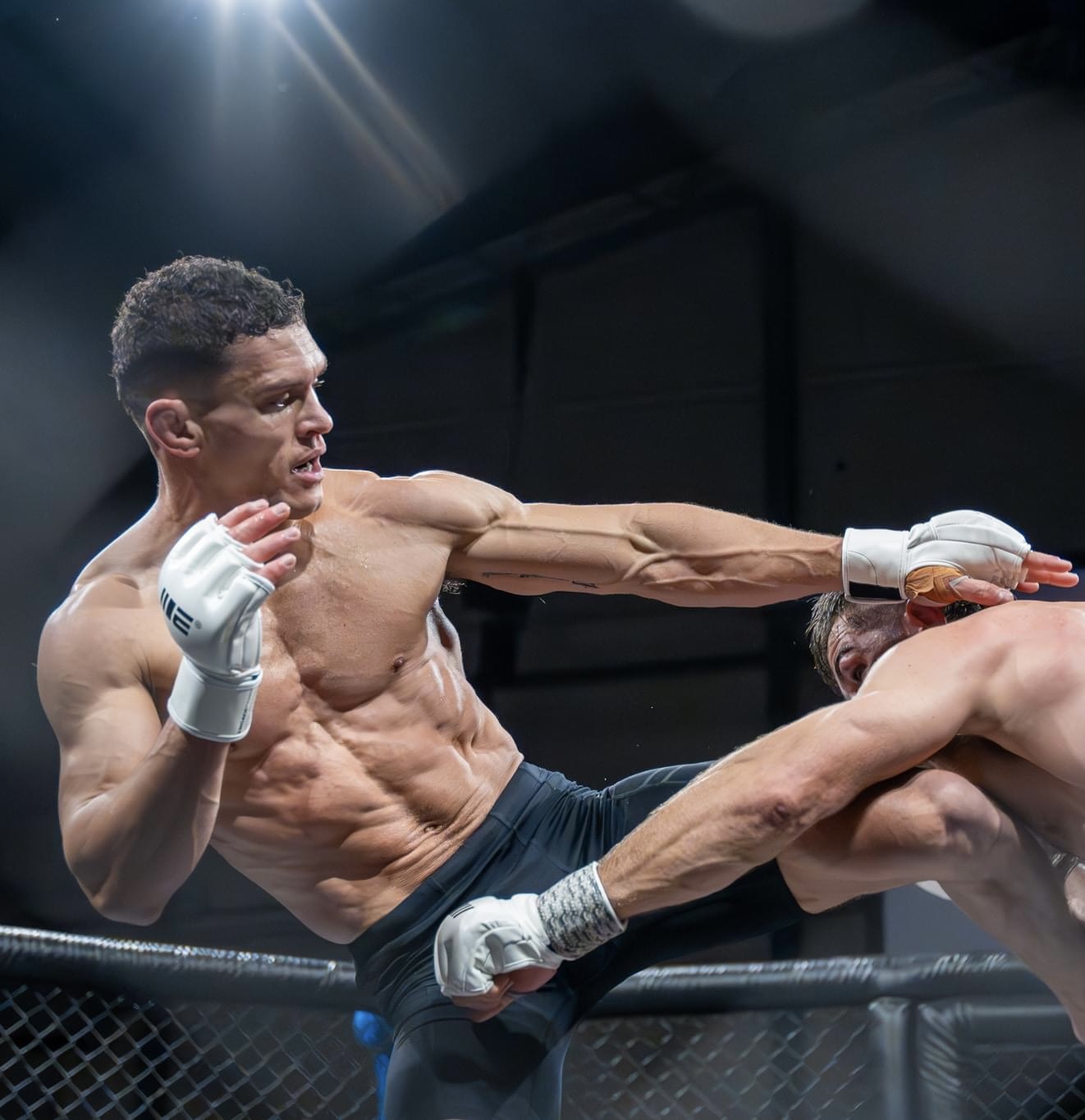 MMA fighter landing a high kick during a competitive bout