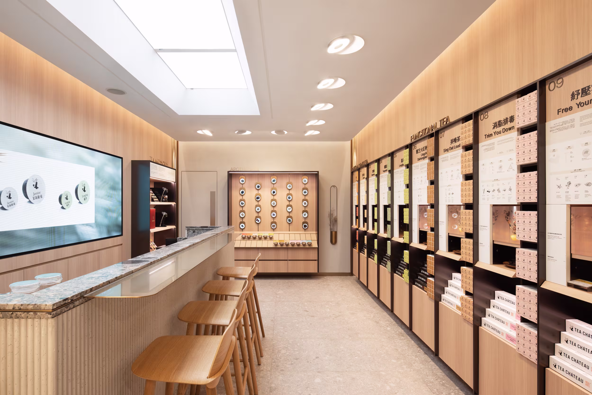 Tea Chateau store interior looking towards the apothecary pod wall with illuminated resin-encased tea ingredient specimens