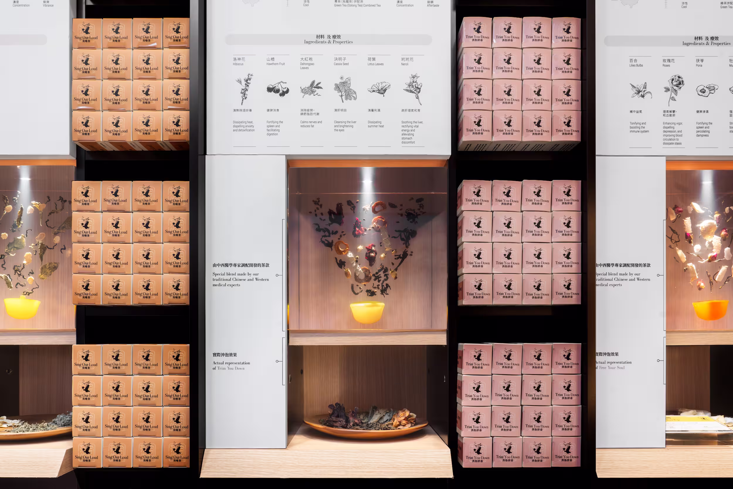 Tea Chateau wall-mounted brass capsule vase with dried botanical branches, decorative detail between store columns