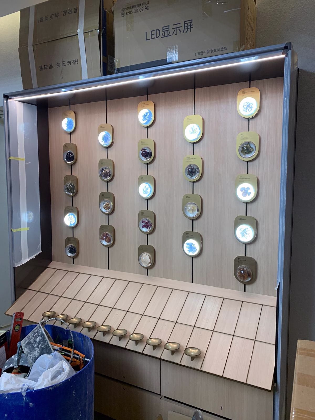 Construction progress photograph of Tea Chateau showing hero product wall carcassing with numbered bays prior to finish installation