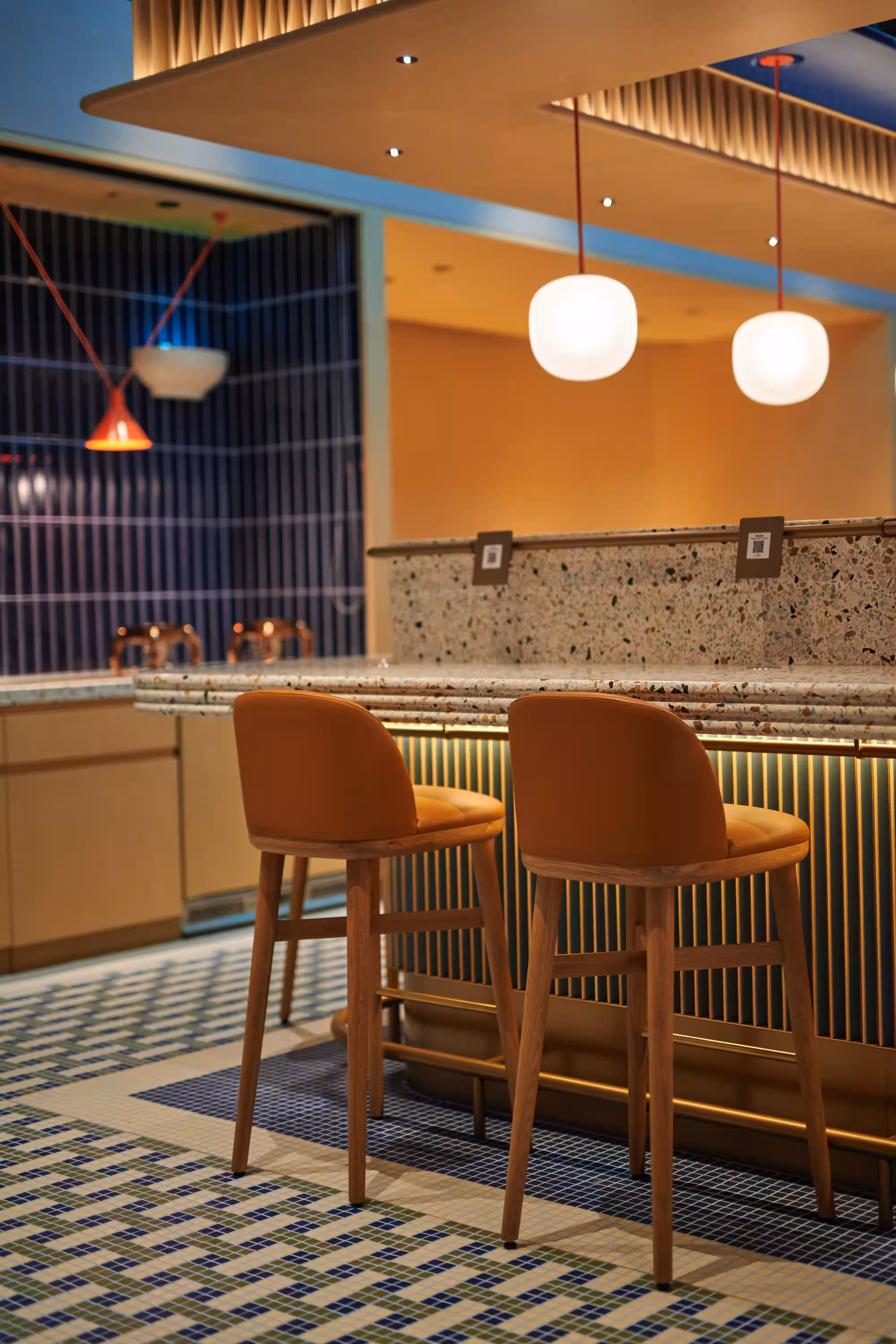 Mian Cart Noodle Bar banquette seating at Studio City Macau with upholstered bench and feature wall backdrop