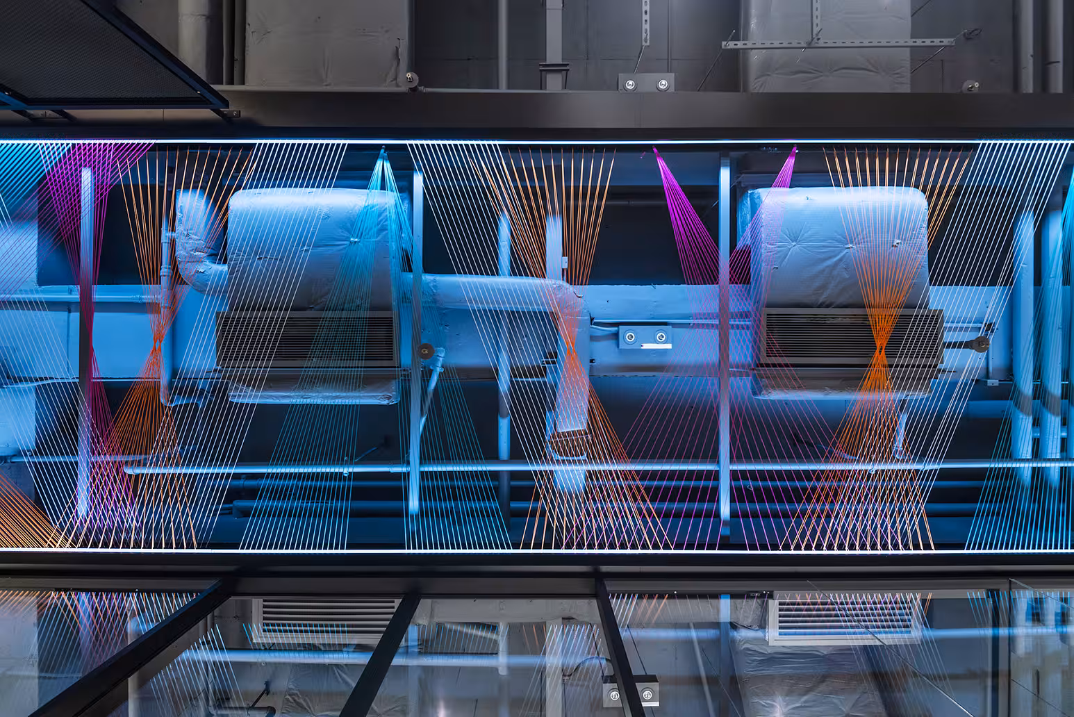 ThreeSixty Group office boardroom with long executive table, pendant lighting, and glazed wall overlooking the workspace