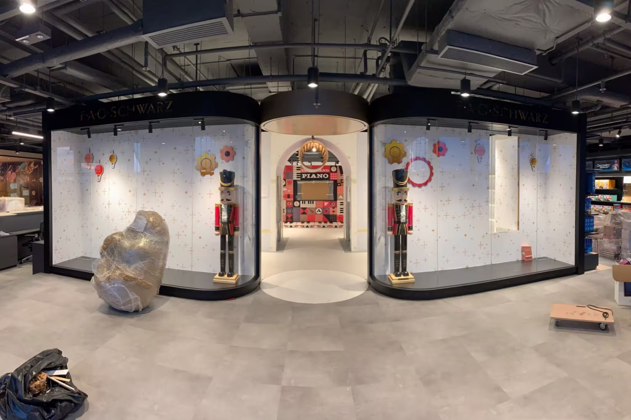 Construction progress photograph of FAO Schwarz Hong Kong showing joinery and display unit installation nearing completion