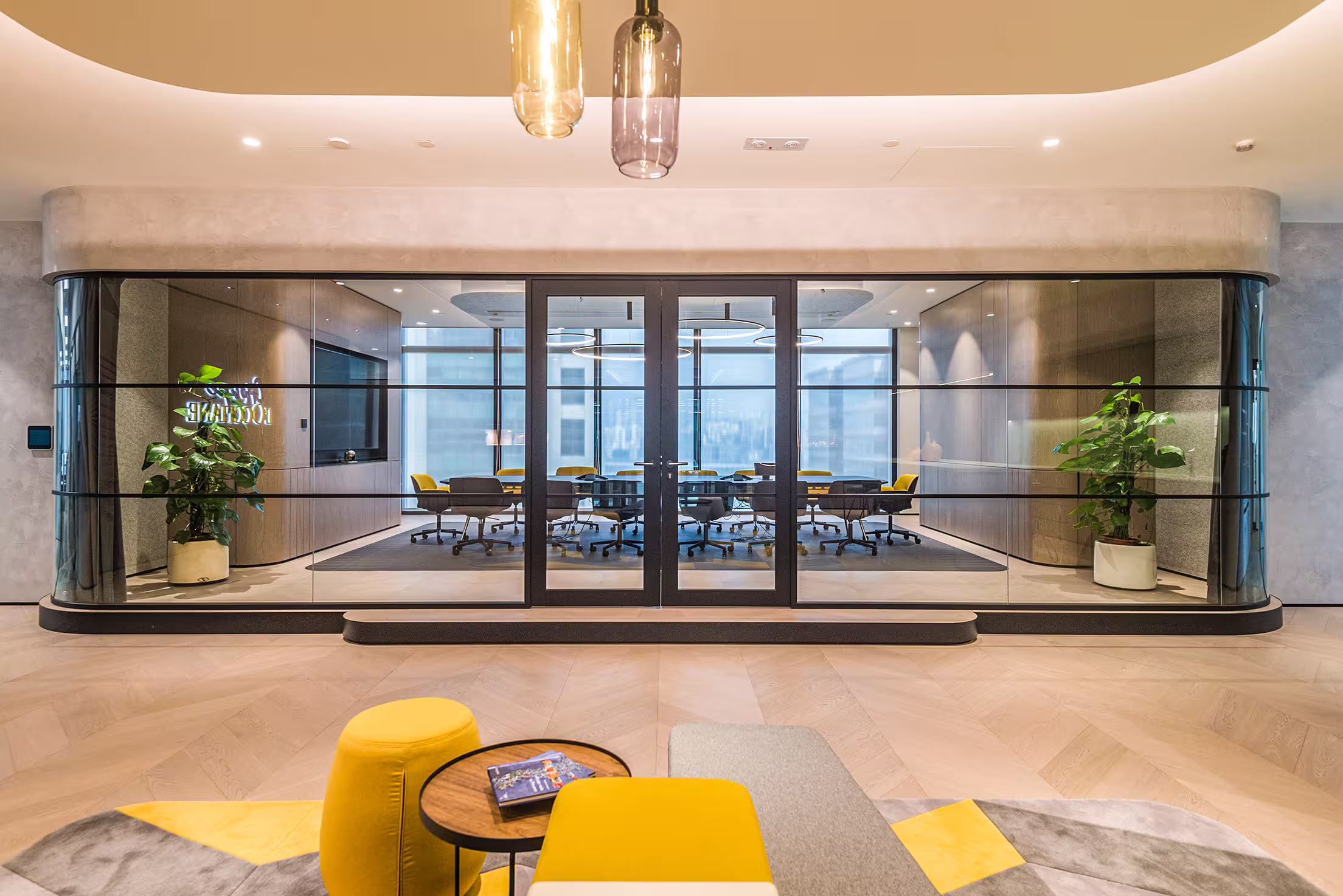 L'Occitane Asia headquarters boardroom at K11 Atelier Hong Kong with executive meeting table, display screen, and glazed partition walls