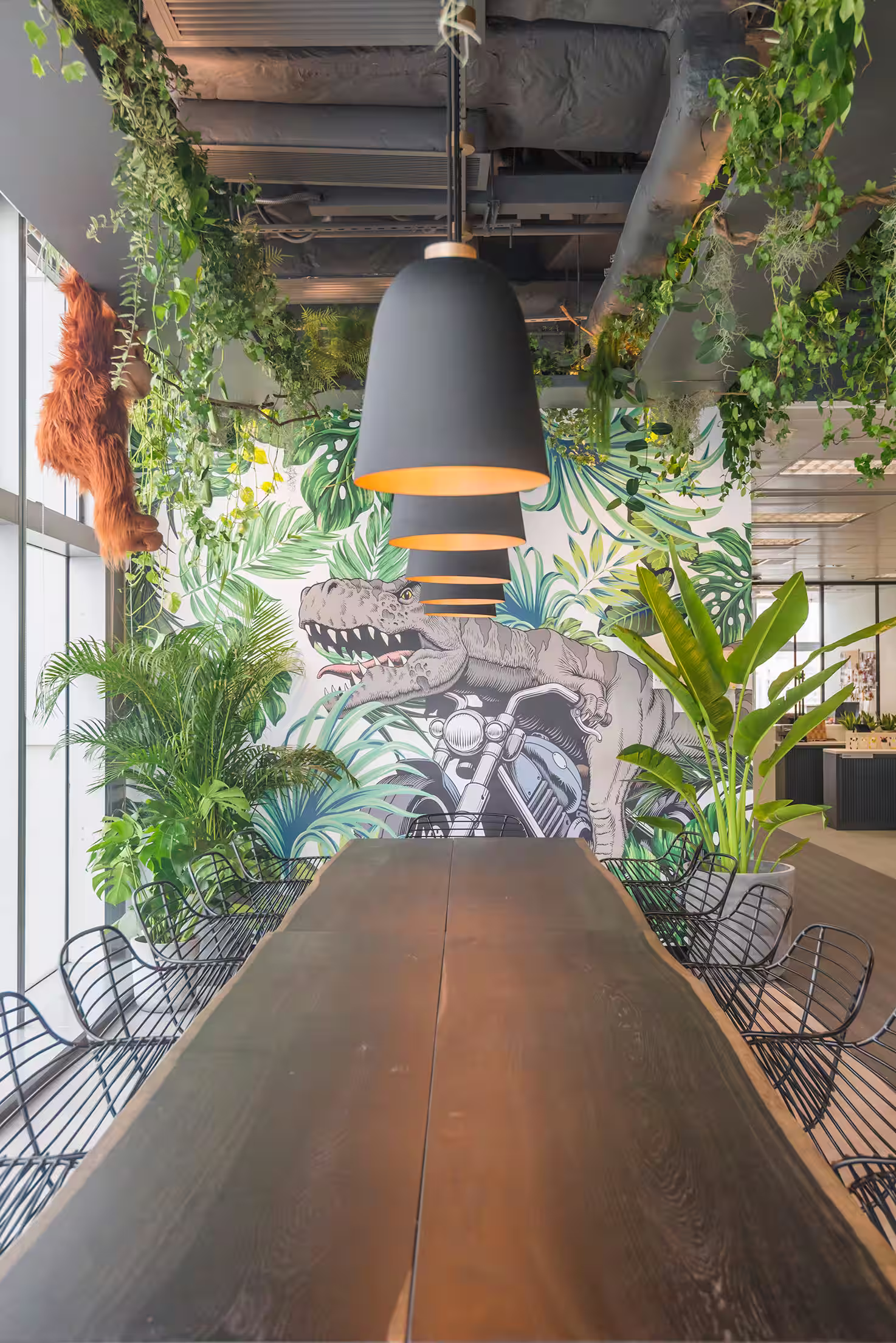 ThreeSixty Group office pantry bar counter with pendant lighting, concrete finish, and social dining area