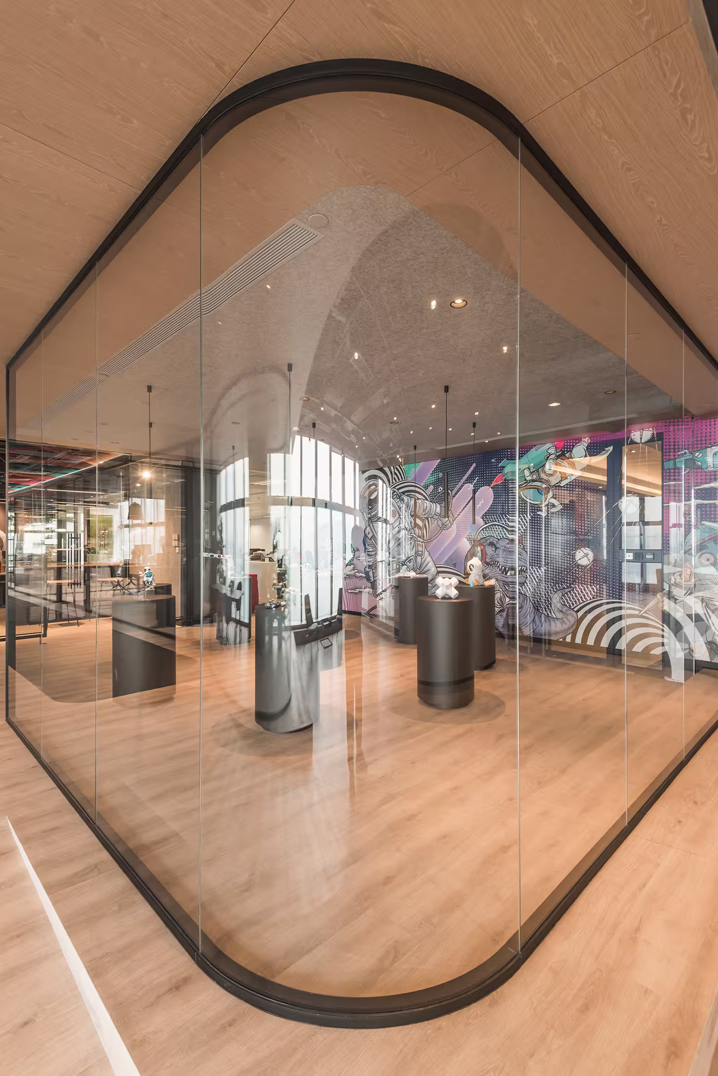 ThreeSixty Group office lounge area with green velvet seating, potted plants, and exposed concrete columns