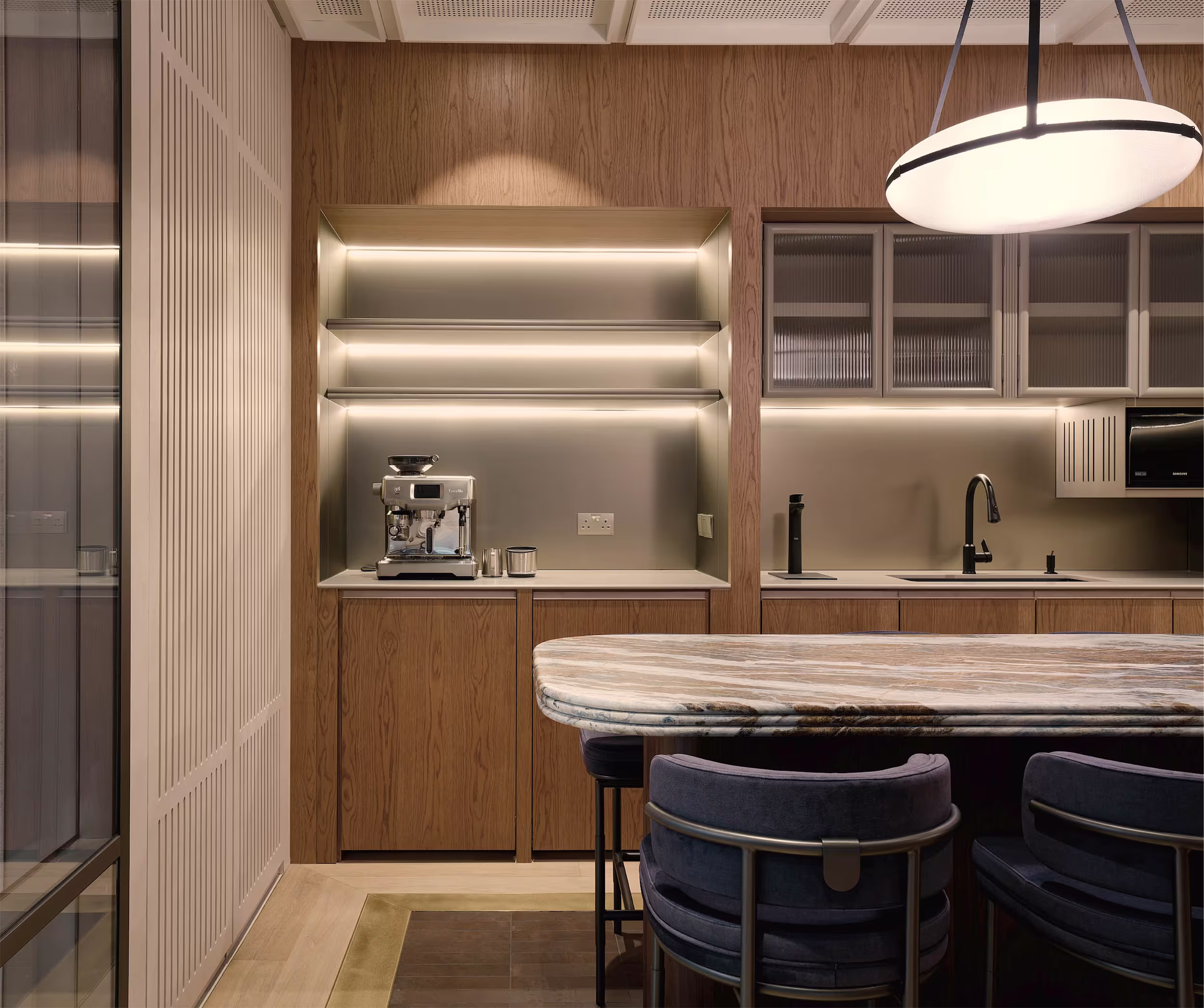 Silvercrest Singapore office visitor waiting area with leather seating and marble side table near reception