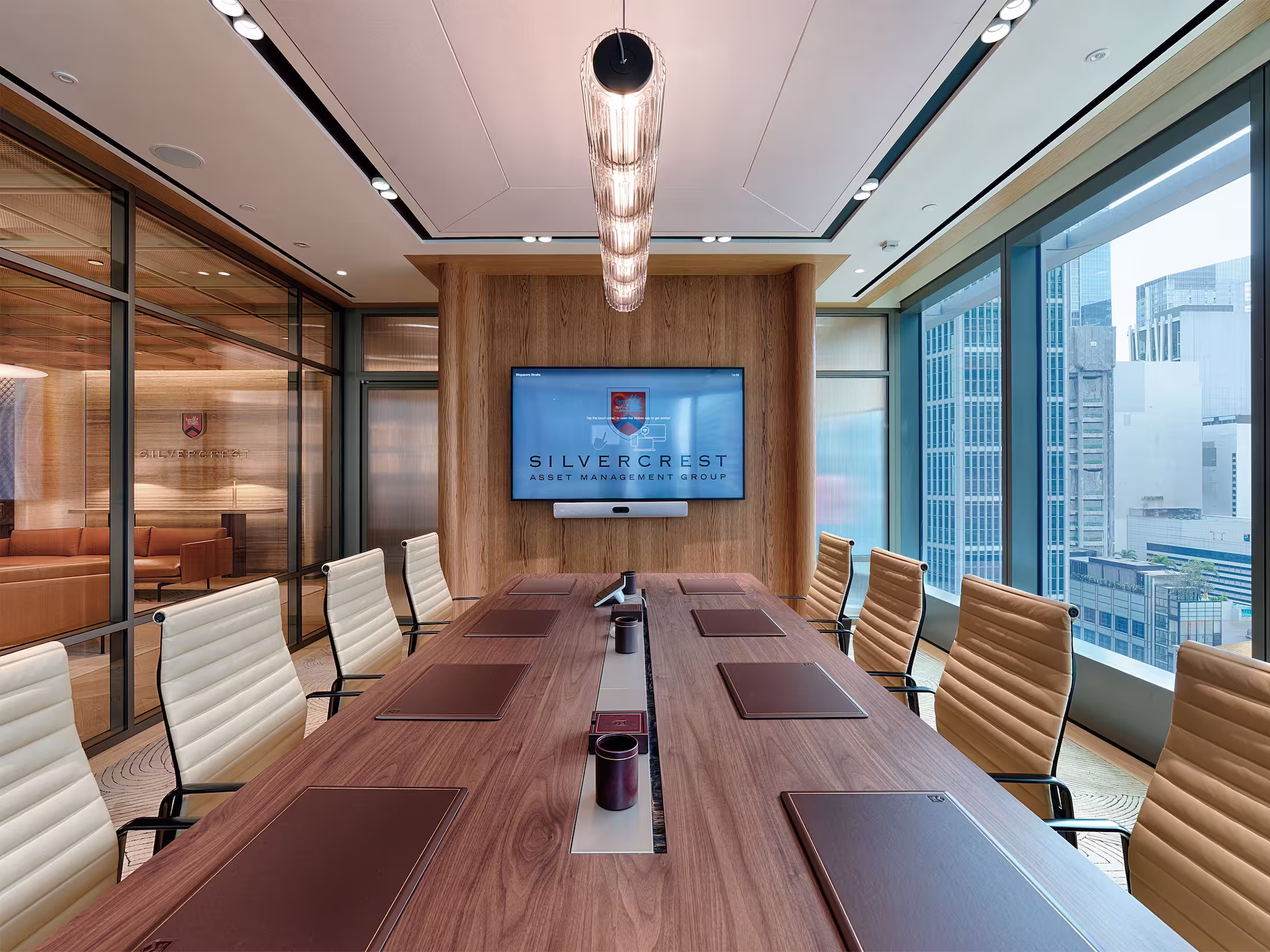 Silvercrest Singapore office reception desk detail with marble counter, brass accent panel, and branded arrival design