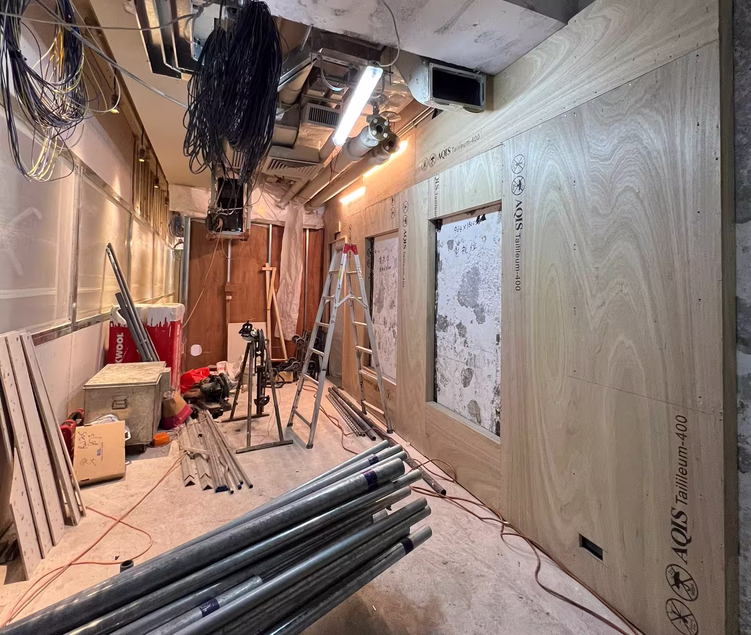 Construction progress photograph of Yau Shing Commercial Centre showing interior podium renovation works and ceiling installation