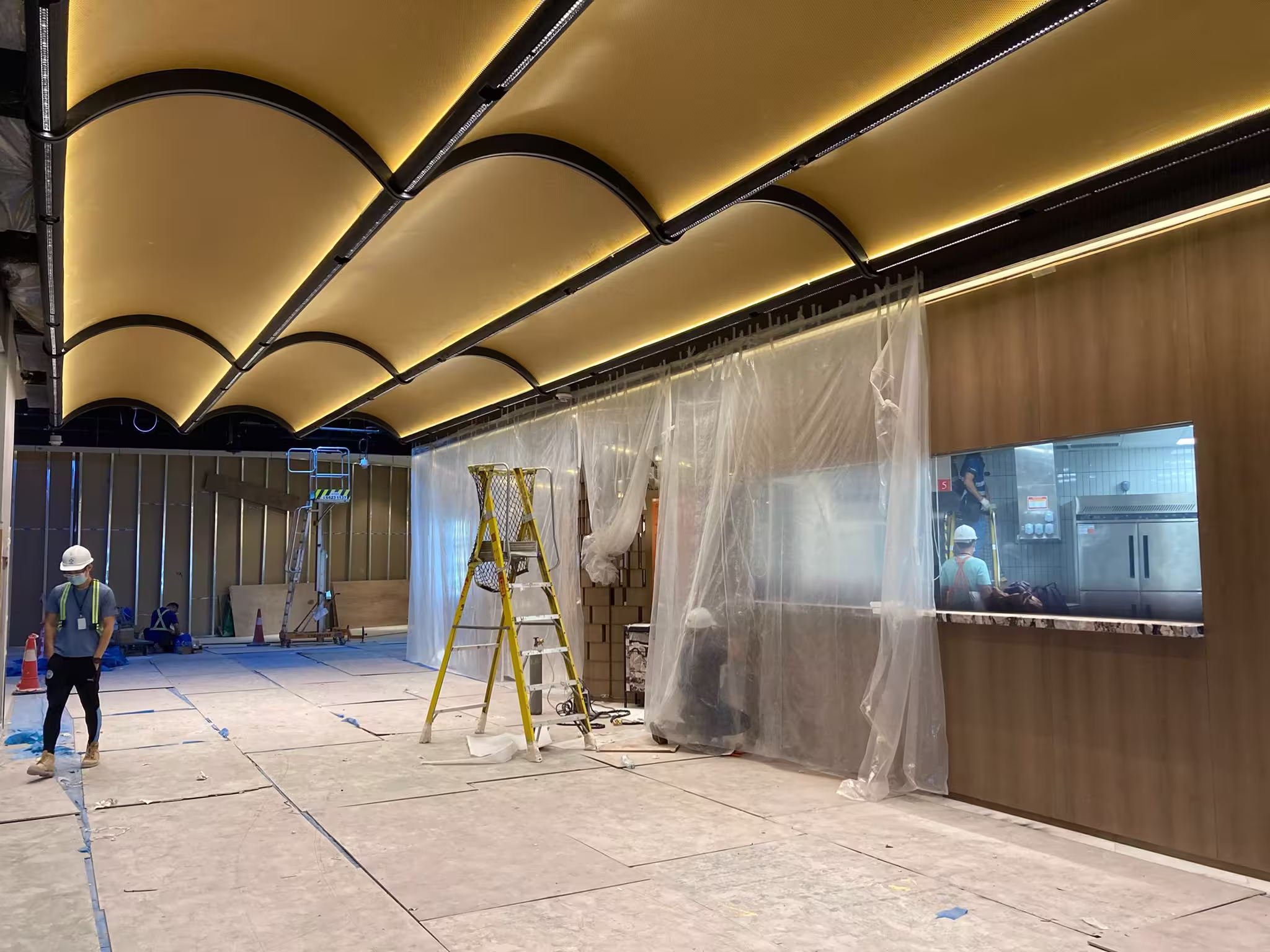 Construction progress photograph of Din Tai Fung Studio City Macau showing joinery installation and finishing works nearing completion