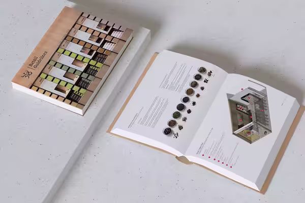 A closed 3/6 Texture Guidelines book next to an open book displaying text, images of various textures, and a 3D model of a building interior.
