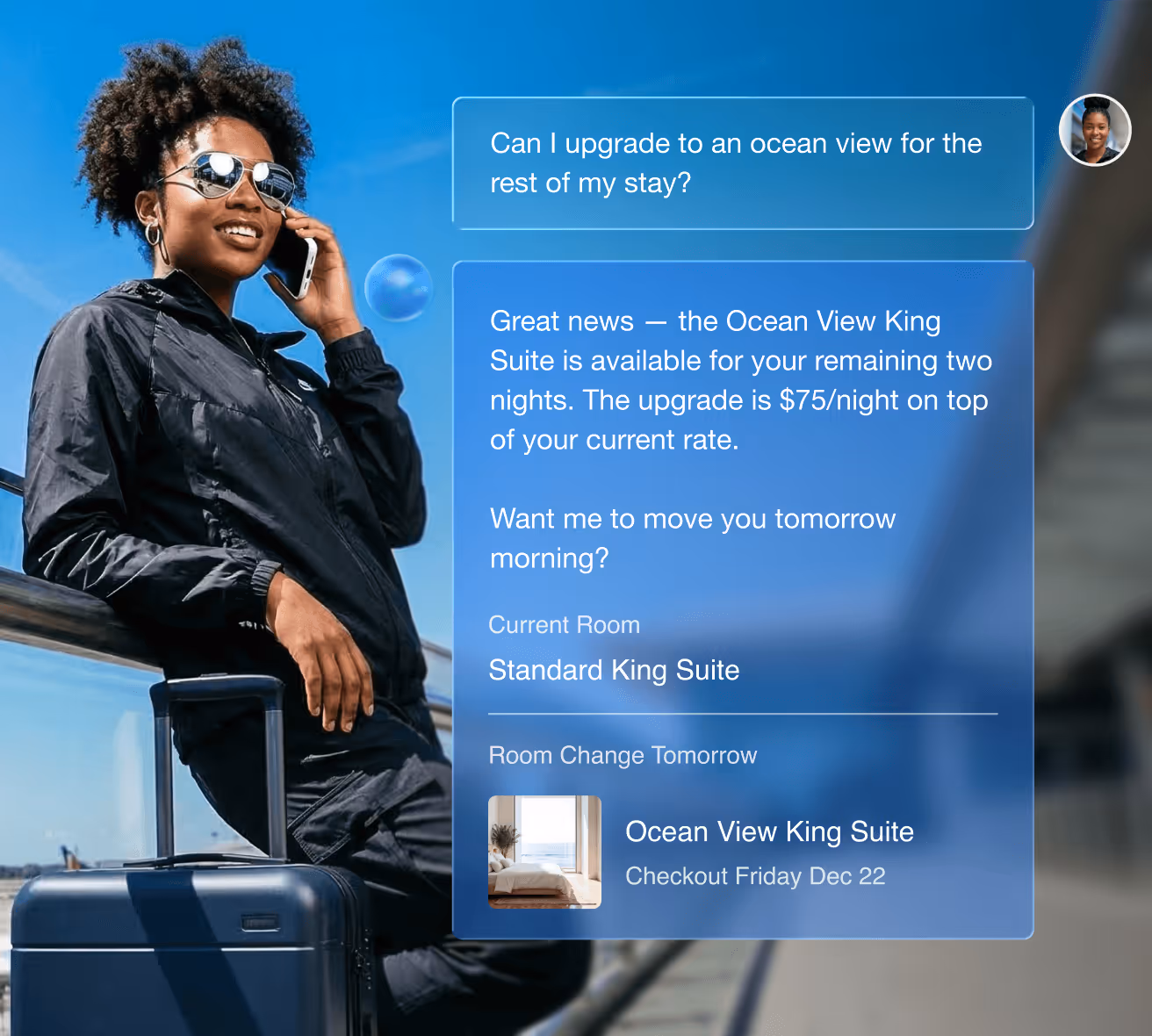 A woman sitting on a couch smiling while using her smartphone, with a chat interface showing a conversation about upgrading to an Ocean View King Suite for $75 extra per night.