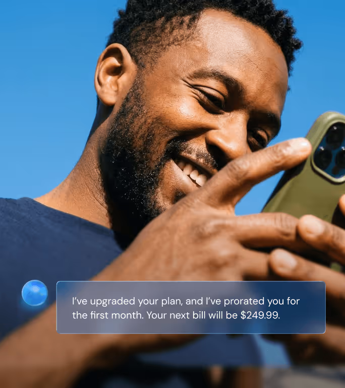 Smiling man holding a smartphone outdoors with a message overlay stating a plan upgrade and next bill amount of $249.99.