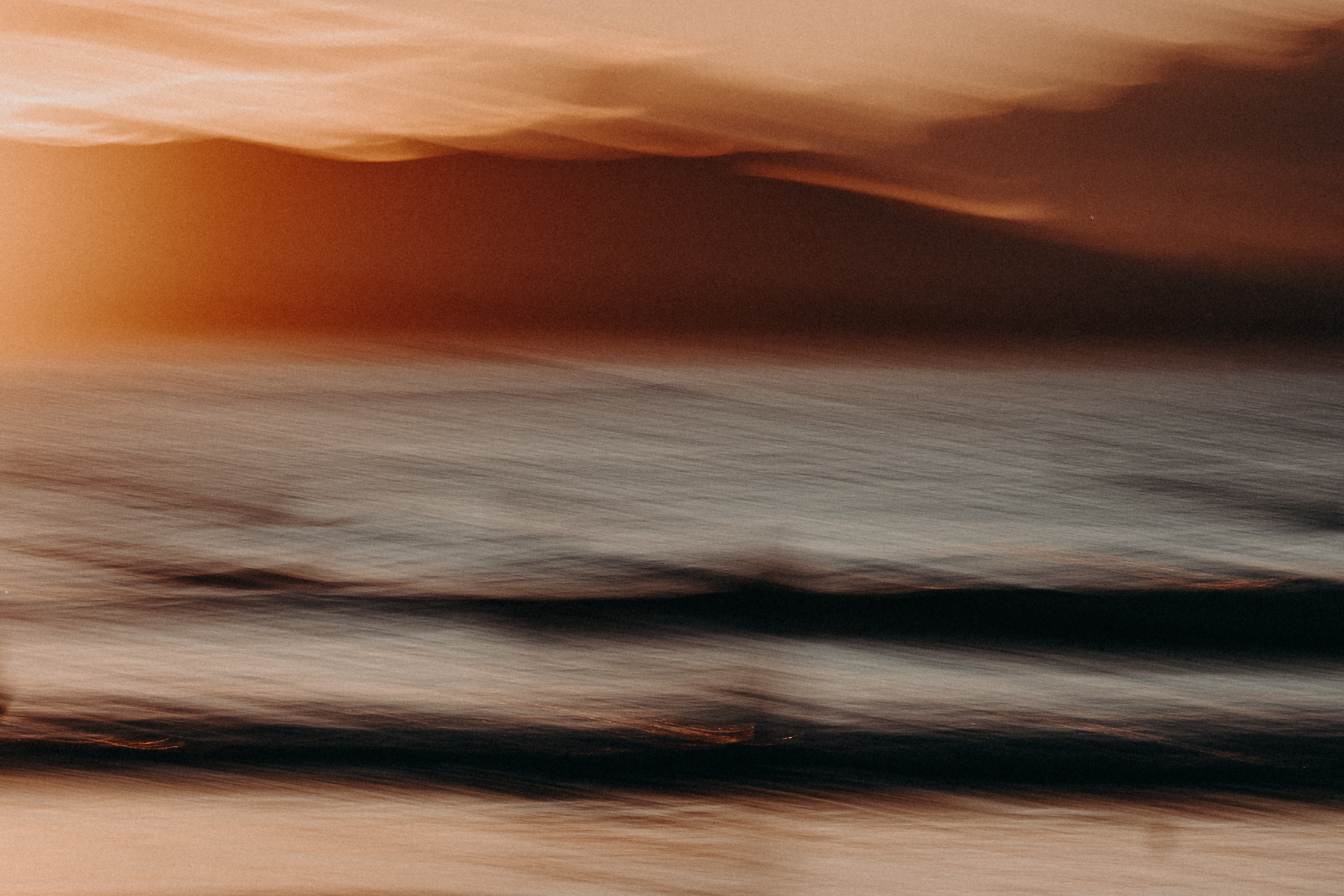 Blurred surf photography exploring motion and water texture.
