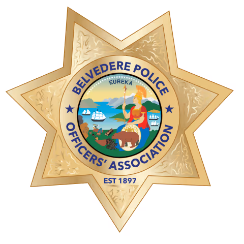 Belvedere Police Officers' Association badge featuring a seven-point star with a central emblem showing a bear, a woman holding a spear, ships, and the word 'Eureka'.