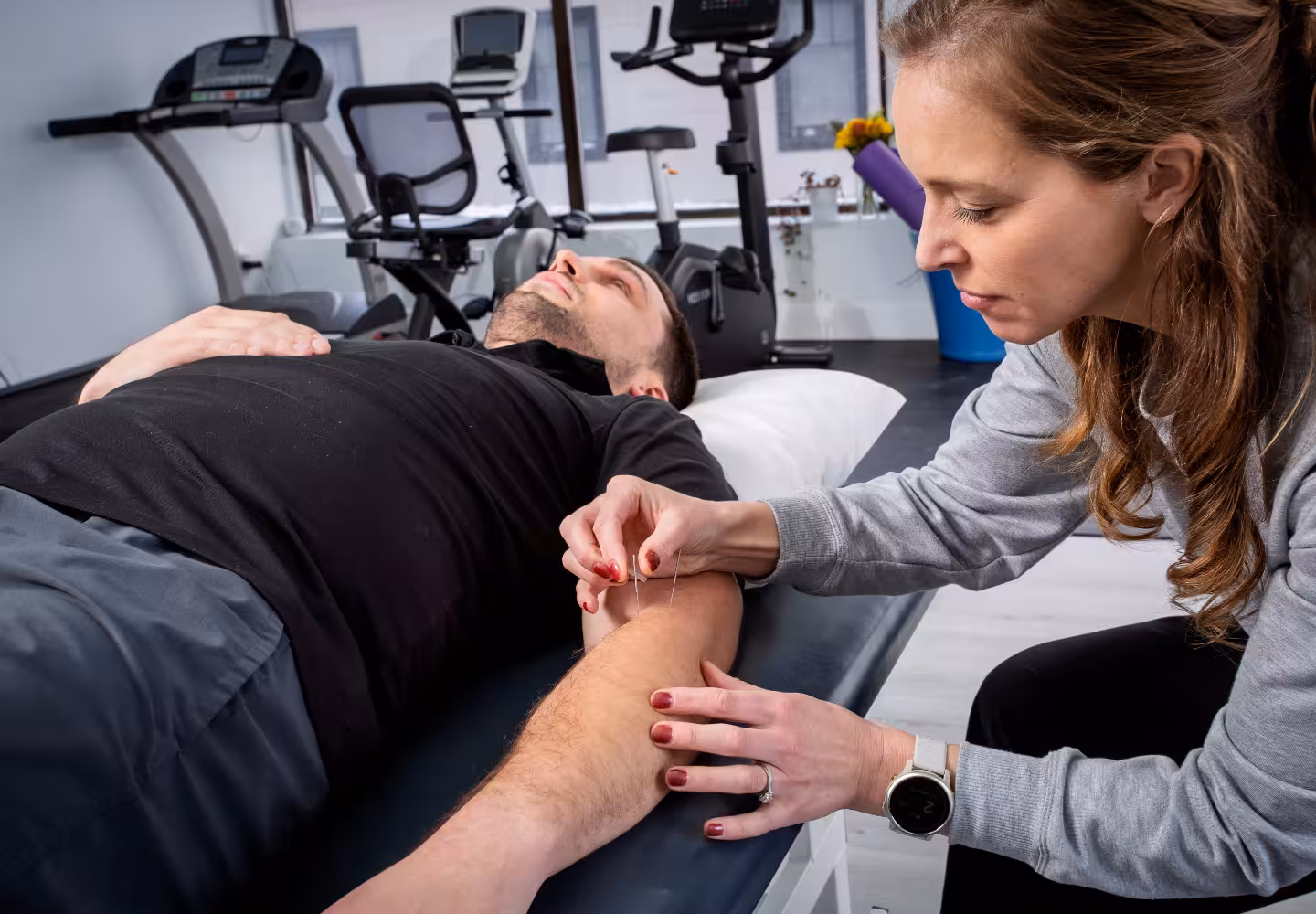 a physiotherapist doing acupuncture