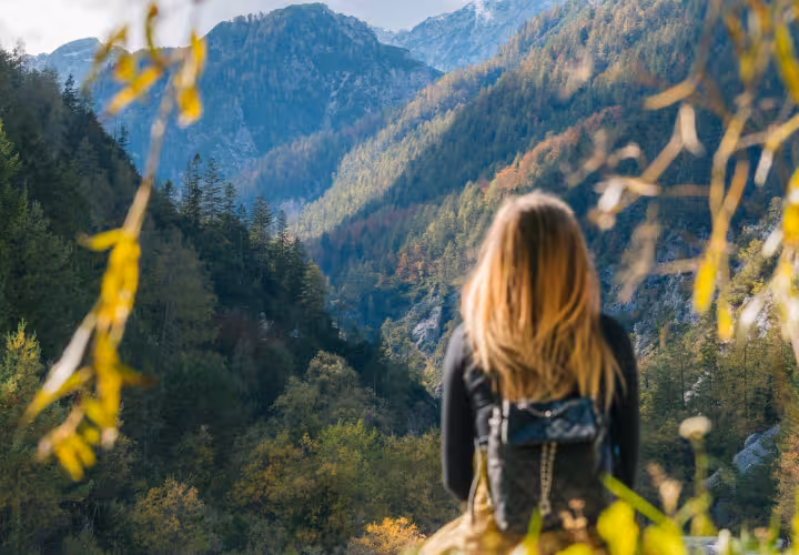 Woman sitting overlooking a mountain valley