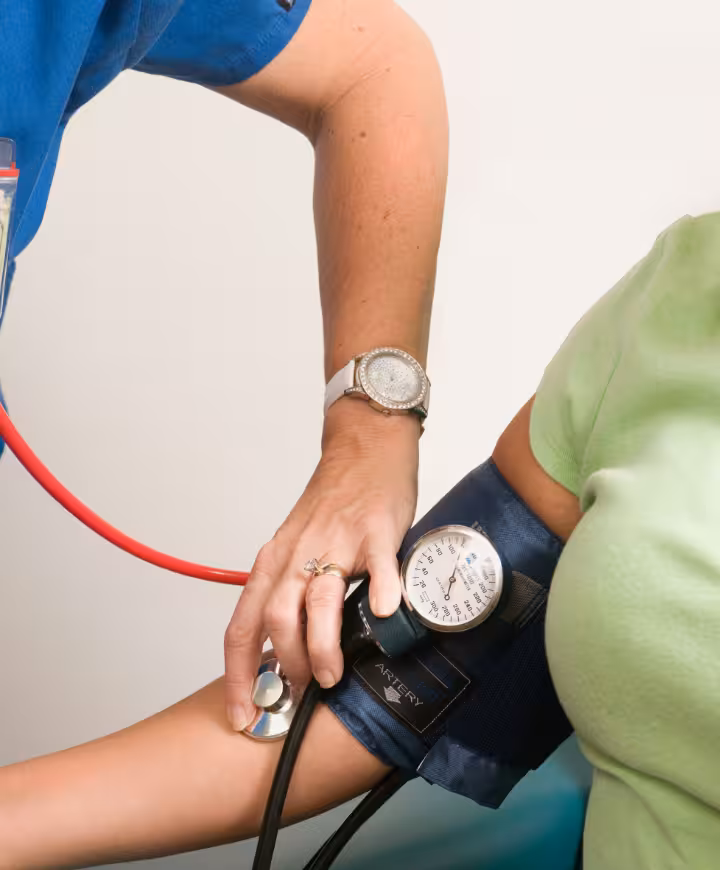 Nurse practitioner measuring a patient's blood pressure