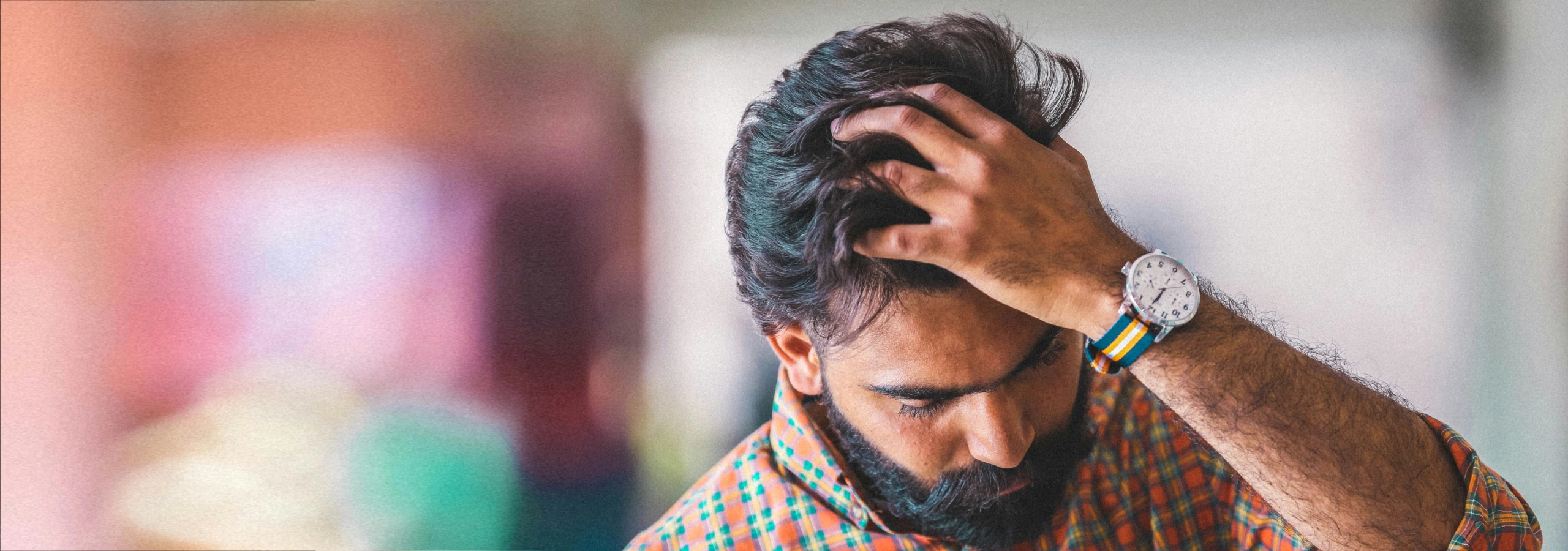 man in pain holding his head