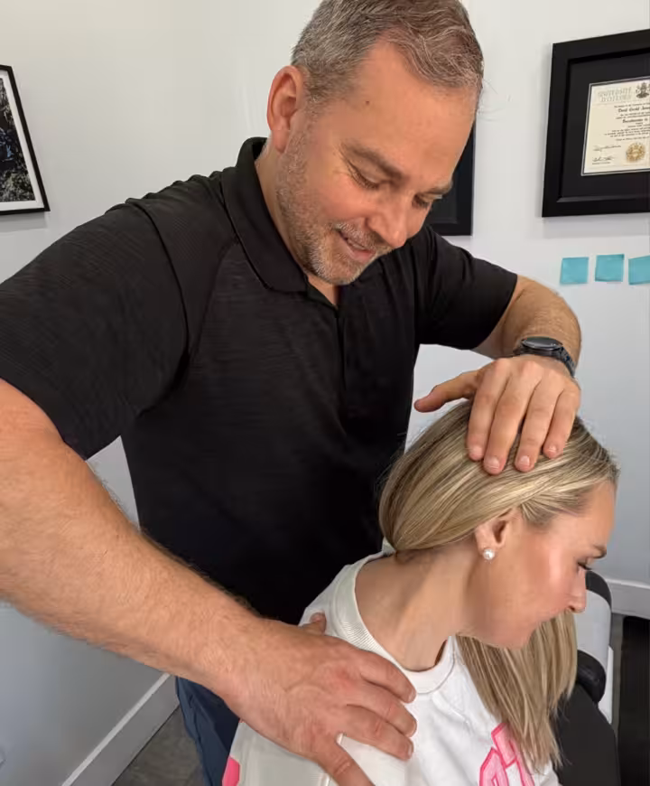 a TIHC chiropractor employs active release soft tissue massage on a patient's shoulder