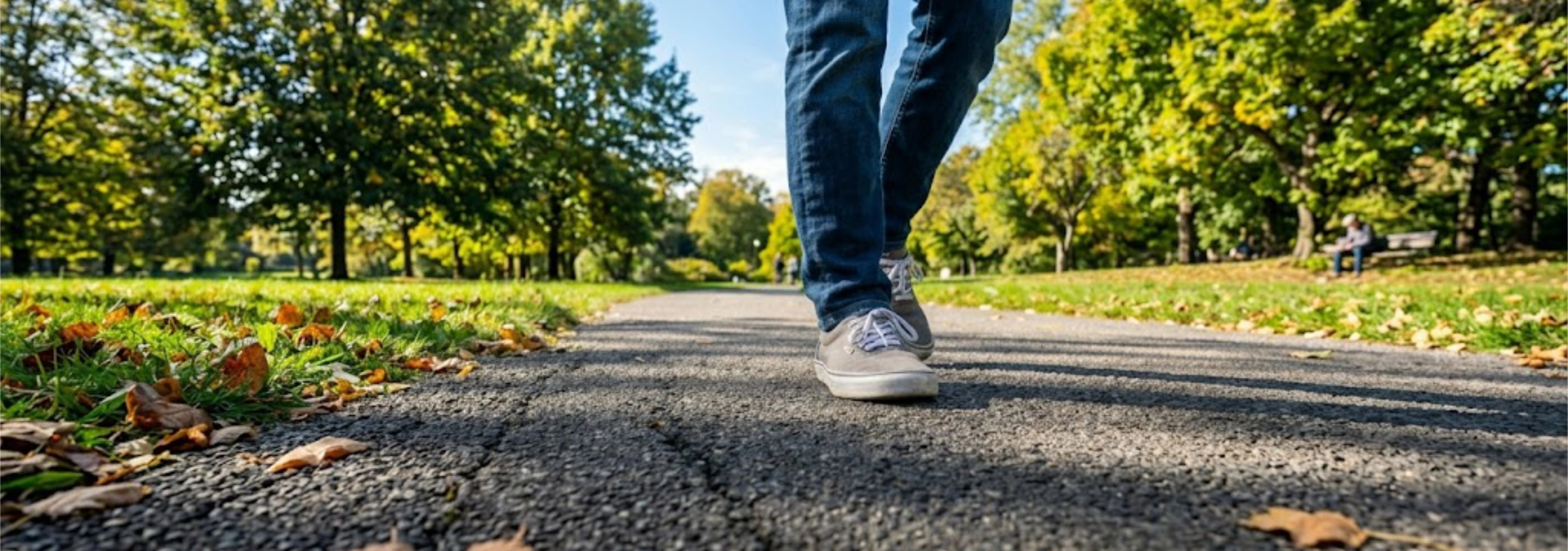 lower legs and feet of a person walking on a paved road