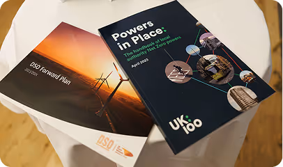 Two books about renewable energy and power placed on a white surface