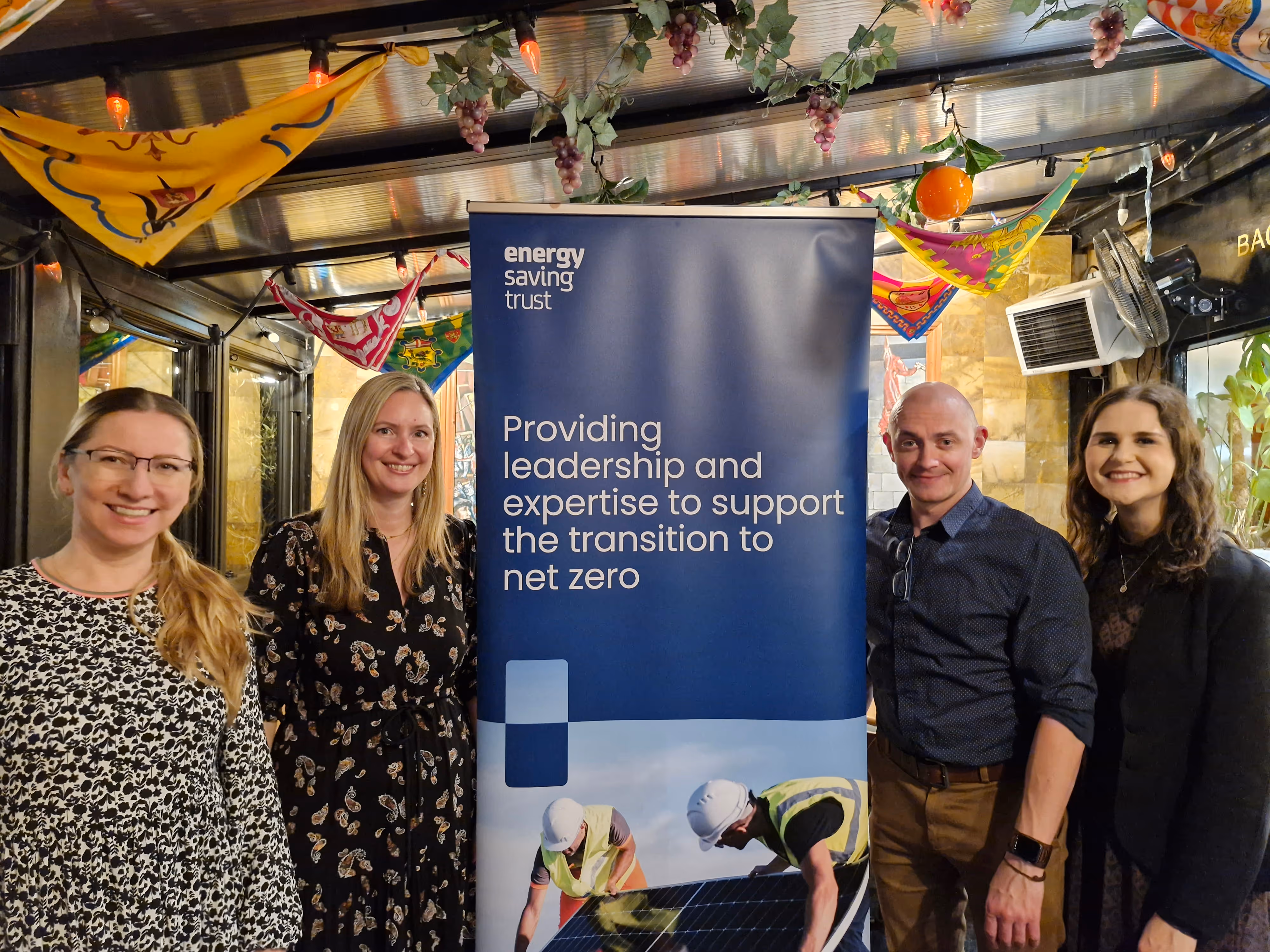 Energy Saving Trust team posing with net zero transition banner