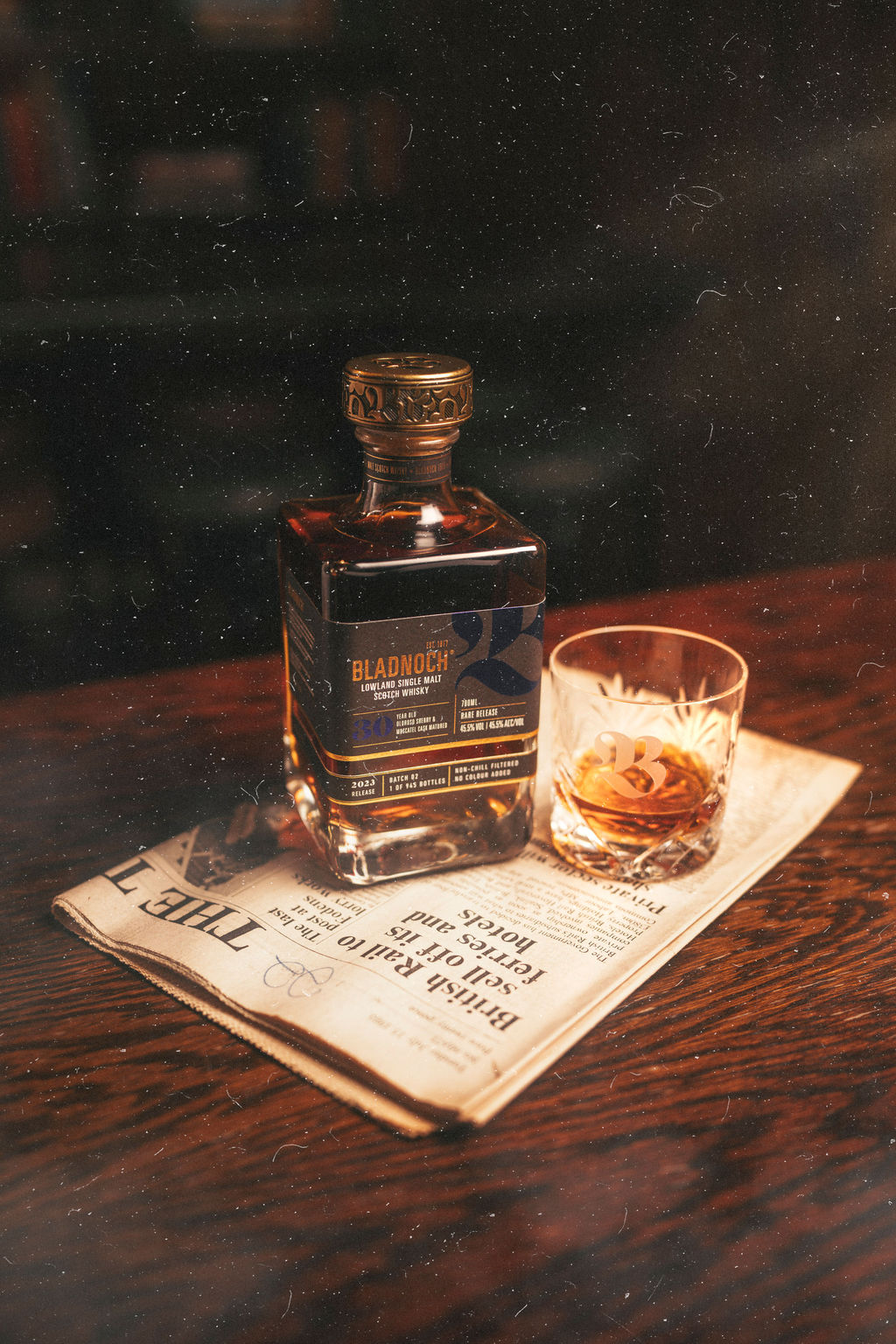 Bladnoch 30 Year Old bottle and a filled glass on a newspaper