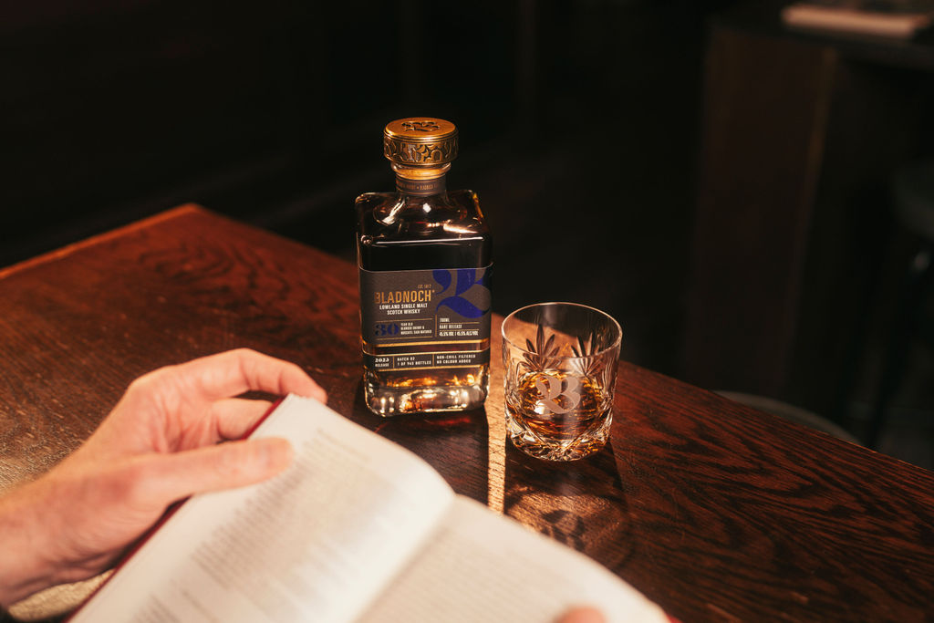 1. A glass of Bladnoch 30 Year Old next to an open book