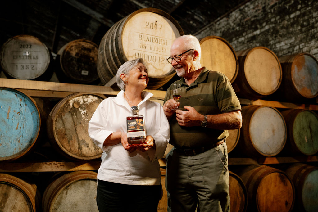 Roddy and Elaine raising glasses of Bladnoch together