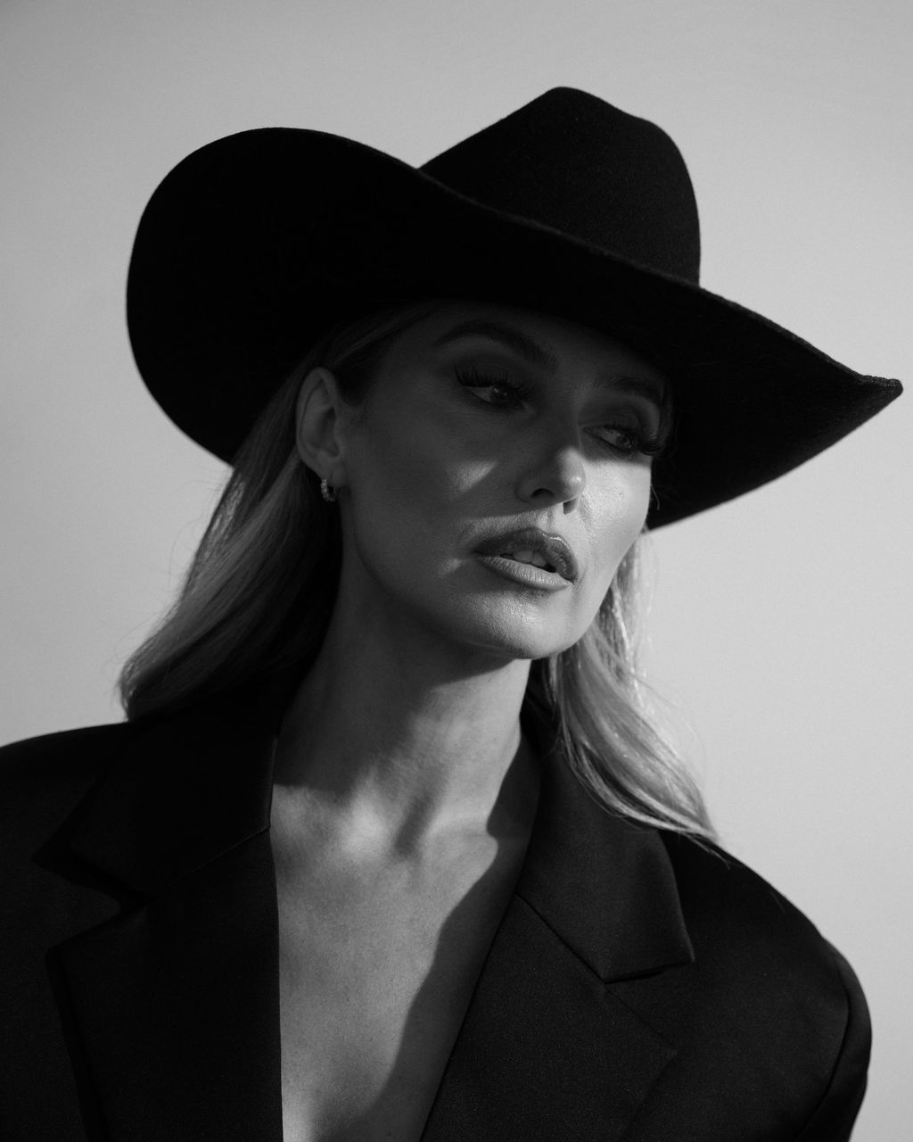 Ashleigh Greenwood in a black felt cowboy hat and blazer, black and white
