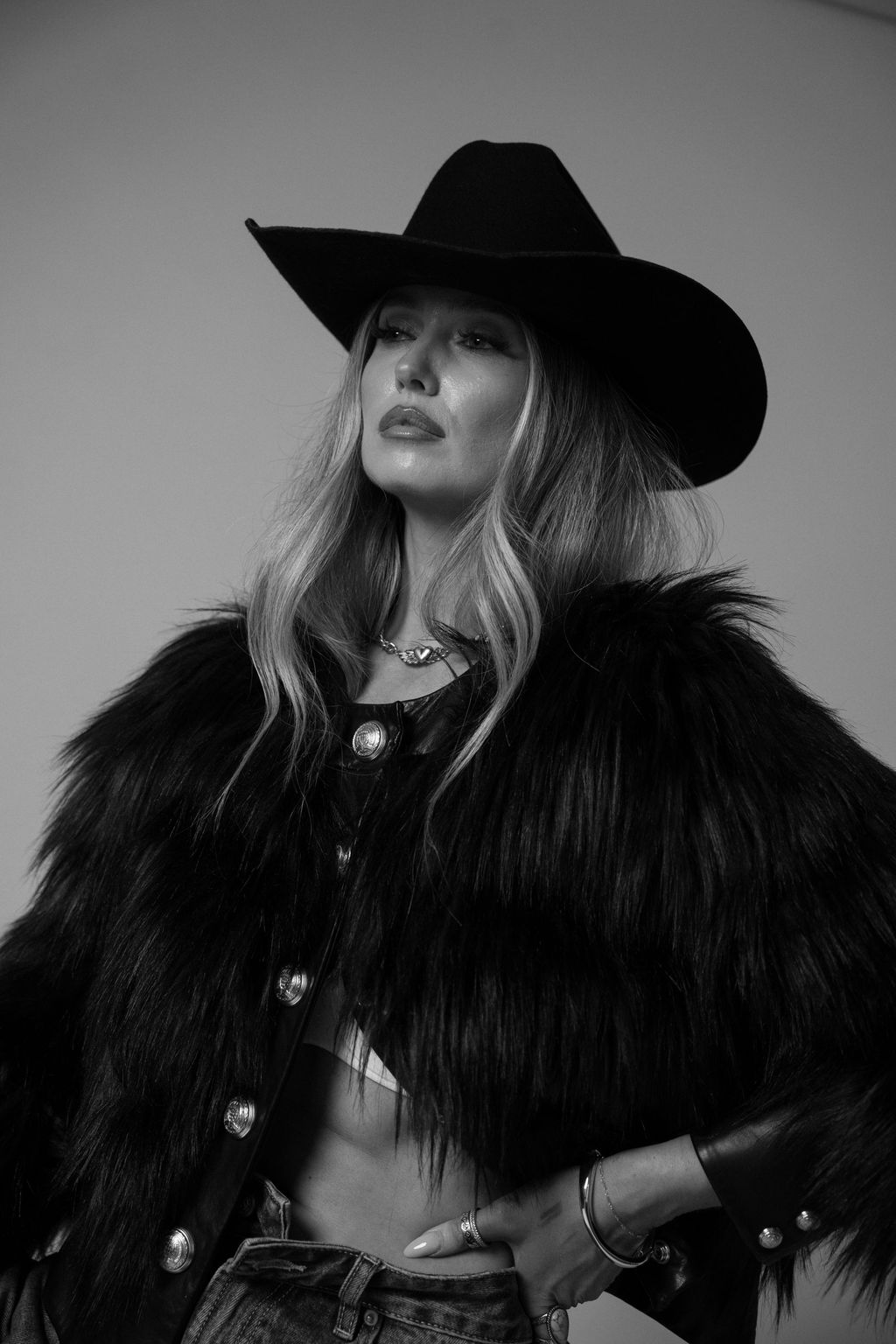 Ashleigh Greenwood in a black feather jacket, black and white