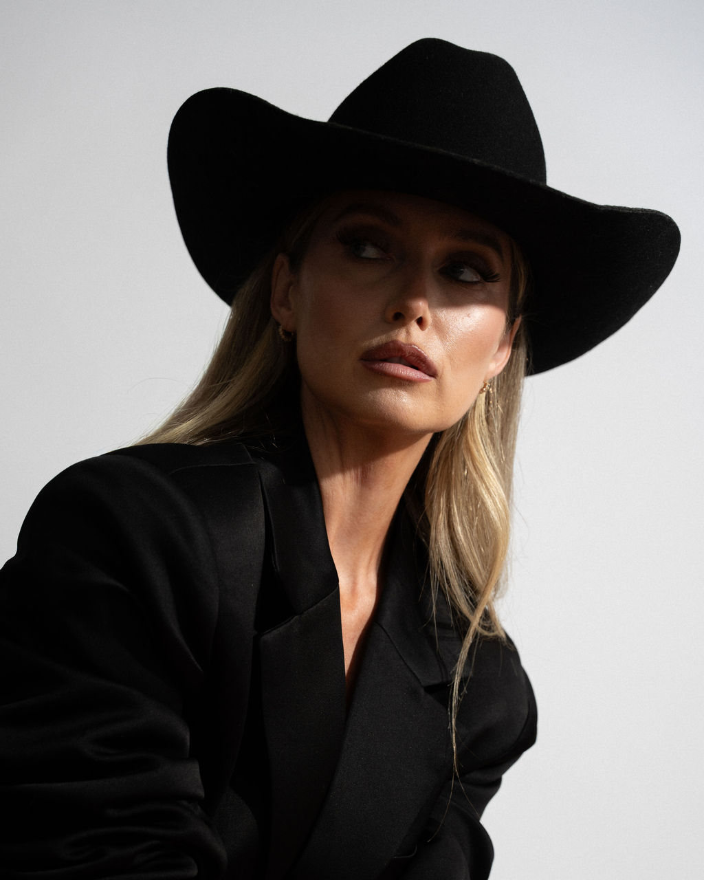 Ashleigh Greenwood in a black felt cowboy hat and blazer, black and white