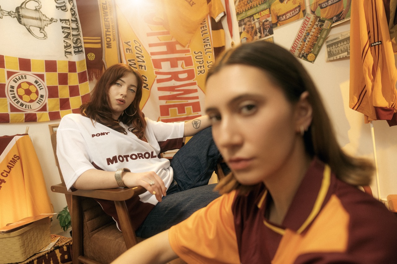 Close portrait of a model in the Motherwell FC 90s home shirt