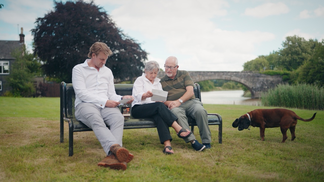 Nick Savage sitting with Roddy and Elaine by the river