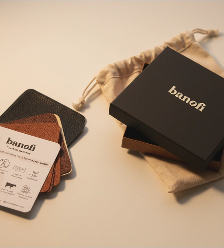 Banofi branded box and fabric pouch next to a set of custom leather material swatches.